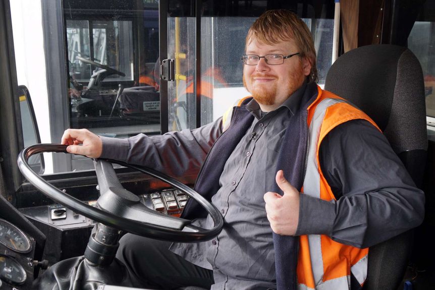 Picture of a client seated in the drivers seat of a bus