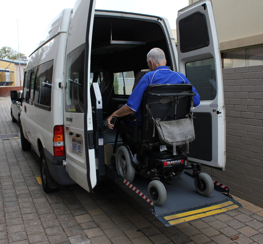 Picture of gentleman in a wheelchair entering a modified wheelchair accessible vehicle
